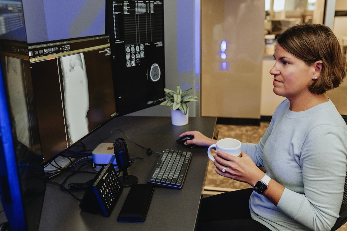 Radiologist reading a brain CT at her teleradiology workstation